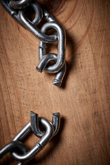 Is it broken or the beginning of something new. Shot of metal chains with a broken link.