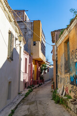 Fototapeta na wymiar ATHENS, GREECE - DECEMBER 20, 2021: Traditional houses and small streets at Anaphiotika district near Acropolis Hill.