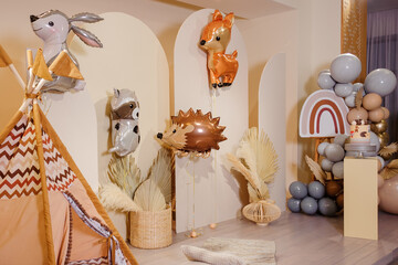 Balloons in the form of animals and wigwam on photo zone.	