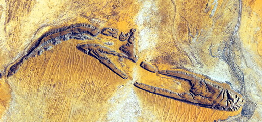 abstract landscape of the deserts of Africa from the air emulating the shapes and colors of fossil...