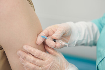 Man being vaccinated by professional in clinic