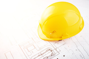 building and architecture background, builder hard hat on engineering blueprints with copy space