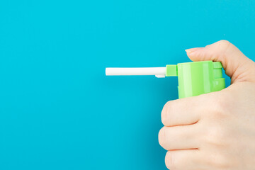 spray aerosol for the treatment of a sore throat, sore throat on a blue background with copy space, a cold medicine