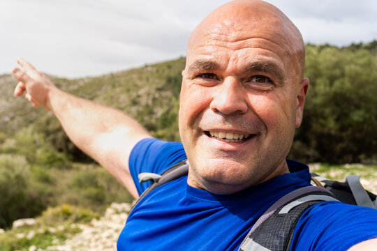 An Adventurous Hiker Man Takes A Selfie In A Natural Environment.