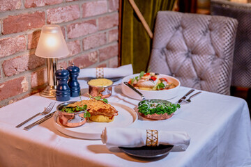 Fototapeta premium Set for two of seafood for dinner, Grilled shrimps or prawns served with lemon, garlic and sauce