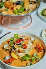Assorted view of dinner table with delicious food set  for two, seafood,Salmon with broccoli, salad, club sandwich, salad with quinoa, tartar from beef