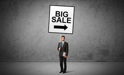 Obraz premium business person holding a traffic sign