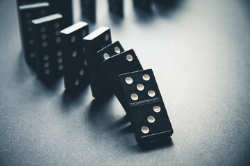 Black dominoes chain on table background - 499458837