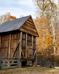 Closeup of a rustic barn in an autumn forest