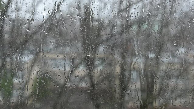 raindrops flow down the window, rain outside the window, video as background