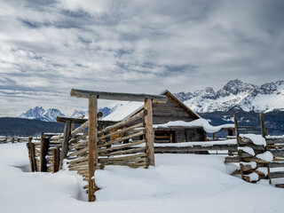 Winter farm coral with Sawtooth mountains in Idaho and snow