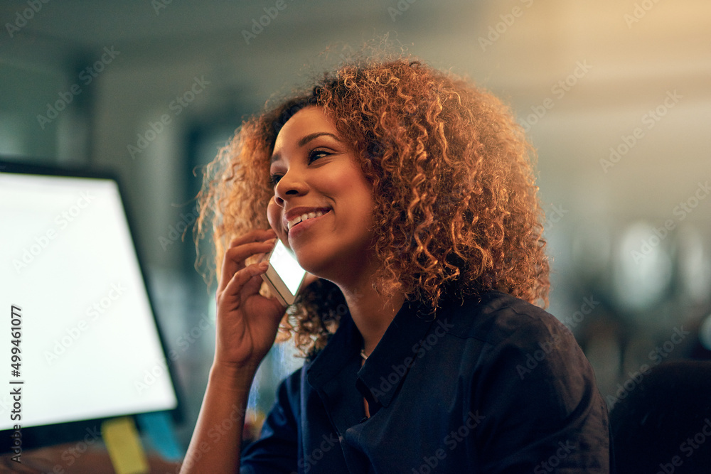 Canvas Prints She stayed late to hear the good news first. Shot of a happy young businesswoman speaking on the phone during a late night at work.