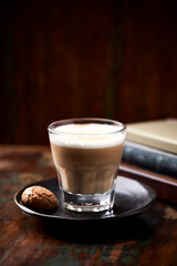 Coffee with milk on rustic wooden background. Soft focus. Close up. Copy space.