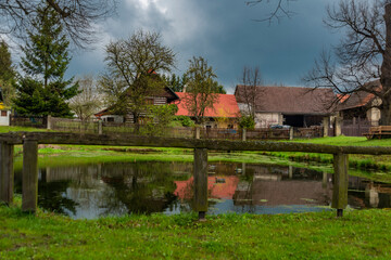 Fototapeta na wymiar Vesec village near Sobotka town with old houses and fresh grass