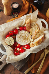 Camembert cheese baked with cherry tomatoes and baguette