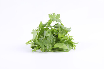 Sliced coriander leaves placed on a white background. It is an edible herb that smells good. It is used for cooking and decorating food.