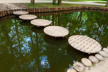 The original bridge for walking across the pond in the form of wooden circles