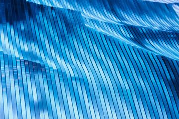 Surface, geometric pattern of the ends of thick glass. Blue glass background, diagonal lines and strips.