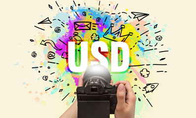 Close-up of a hand holding digital camera with abstract drawing