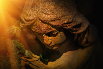 Beautiful sad angel statue in sunlight. Close up.