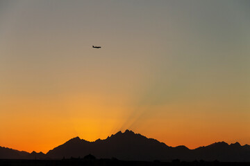 golden sunset on the background of dark silhouettes of mountains