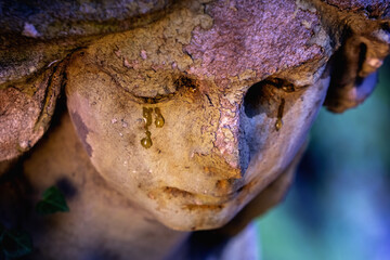 Angel crying . Fragment of an ancient statue.