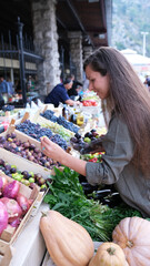 Woman buying fresh figs in a local street shop