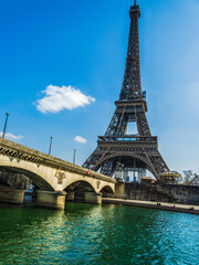 Eifel tower from river Seine with blue sky in Paris