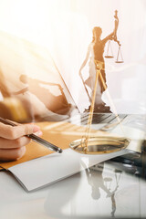 law books and scales of justice on desk in library of law firm. jurisprudence legal education concept.