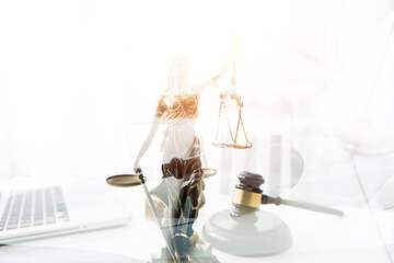 law books and scales of justice on desk in library of law firm. jurisprudence legal education concept.