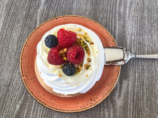 Classic merengue dessert Pavlova topped with berries . High quality photo