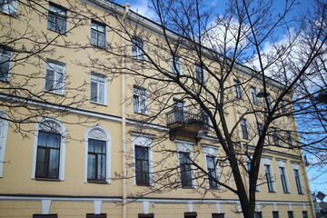 Fototapeta na wymiar Old four-story yellow house in the city center