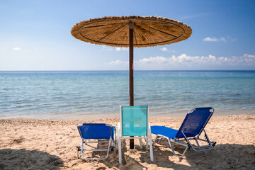 Empty beach chairs with parasol on the beach