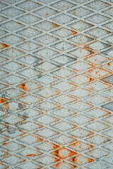 Steel textured metal sheet with rhombuses profile covered with rust. Top view vertical background. Flat lay