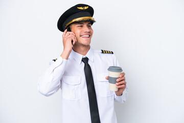 Airplane caucasian pilot isolated on white background holding coffee to take away and a mobile