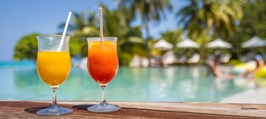 Perfect summer beach resort, poolside with two colorful cocktails. Tropical swimming pool, exotic...