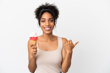 Fototapeta na wymiar Young african american woman with a cornet ice cream isolated on white background pointing to the side to present a product