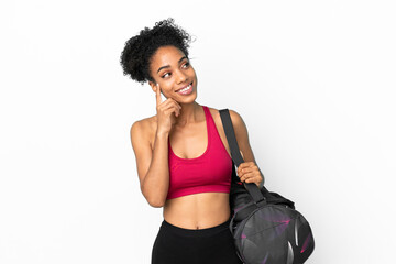 Fototapeta na wymiar Young sport african american woman with sport bag isolated on blue background thinking an idea while looking up