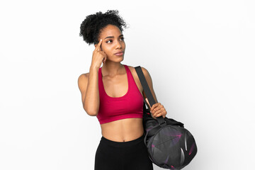 Fototapeta na wymiar Young sport african american woman with sport bag isolated on blue background having doubts and thinking