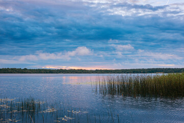 The nature of Belarus, a serene summer morning, a bright dawn on Lake Selyava