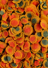 Dry colorful flakes compound fish feed flakes. Top view