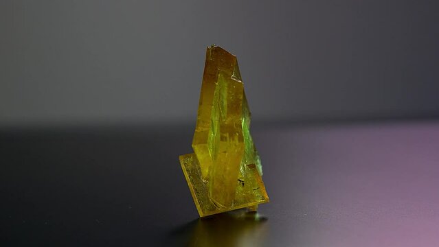 A precious rough stone for jewelry production rotates on an exhibition display