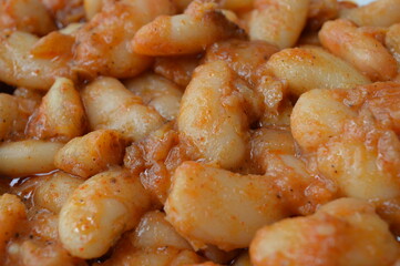 cooked beans with red pepper sauce and bay leaf