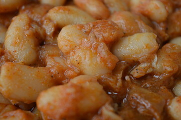 cooked beans with red pepper sauce and bay leaf