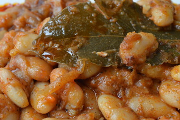 cooked beans with red pepper sauce and bay leaf