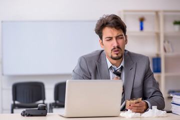 Young businessman employee suffering at workplace