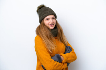 Teenager Russian girl wearing winter jacket isolated on white background with arms crossed and looking forward