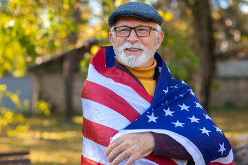 Senior man with american flag outdoor
