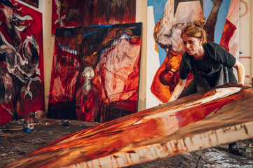 Female painter artist painting and creating her art in a creative studio