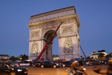 Dismantling work of a temporary art installation on the Arc de Triomphe in Paris